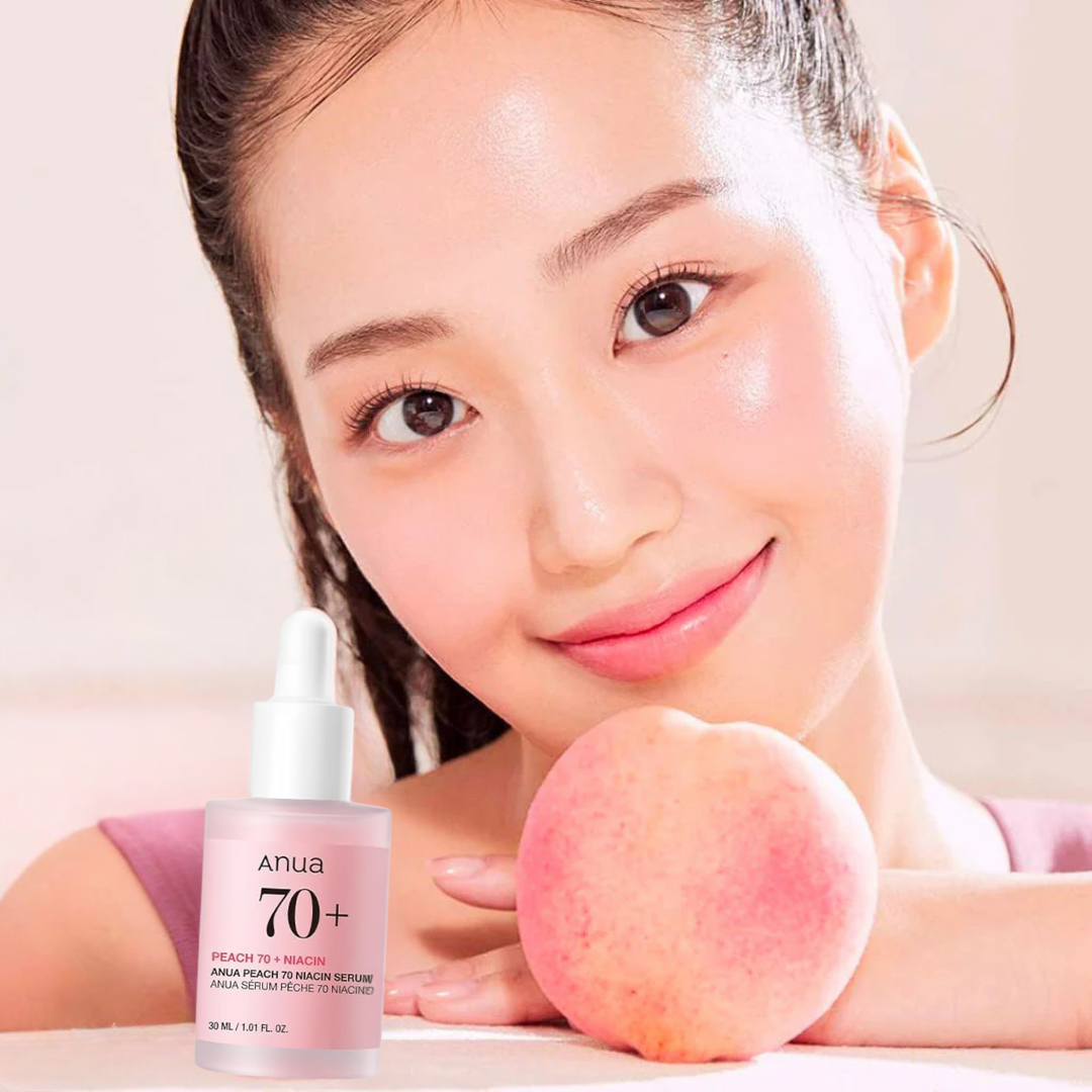 Woman and a peach next to an Anua Peach 70 Niacin Serum on a light background