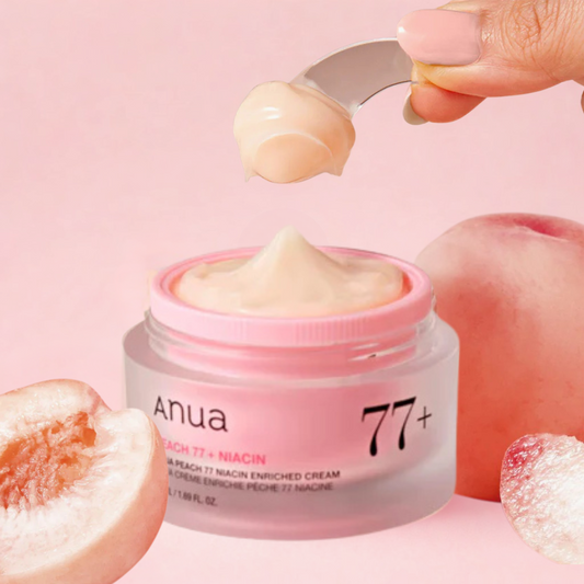 Anua Peach 77+ Niacin Enriched Cream jar with peach slices on a pink background