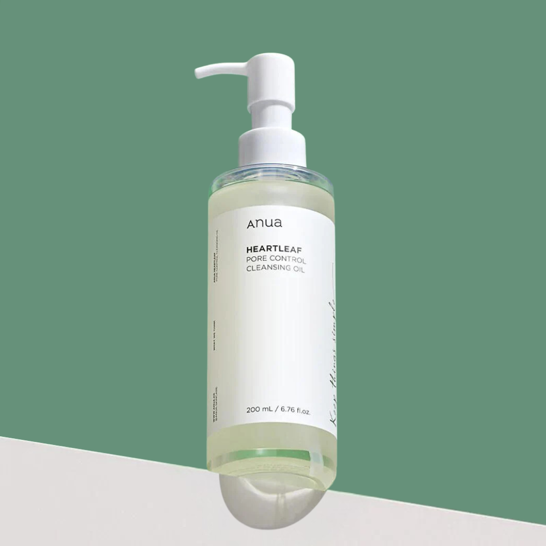 Bottle of Anua Heartleaf Pore Control Cleansing Oil on a green and white background