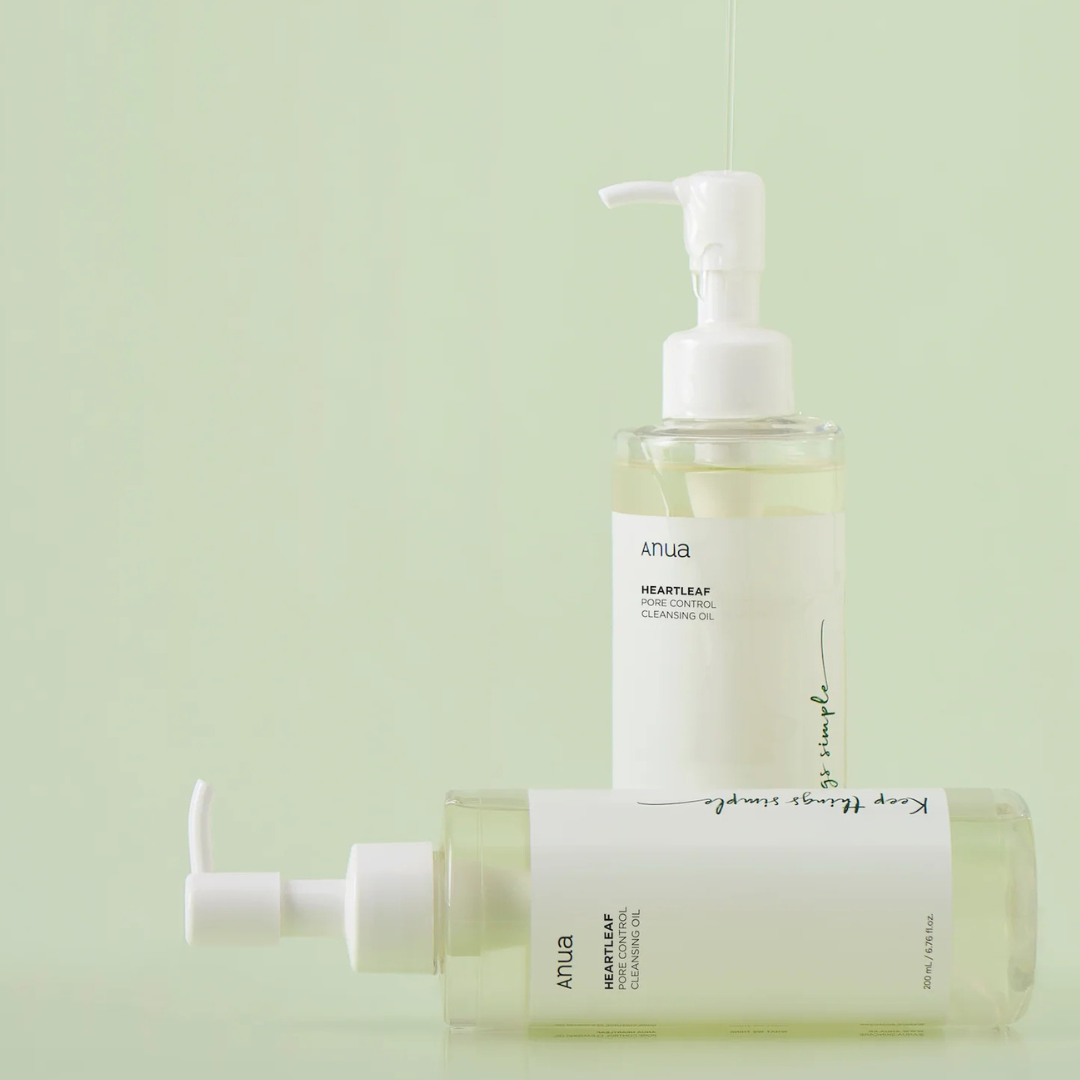 Two bottles of Anua Heartleaf Cleansing Oil on a light green background