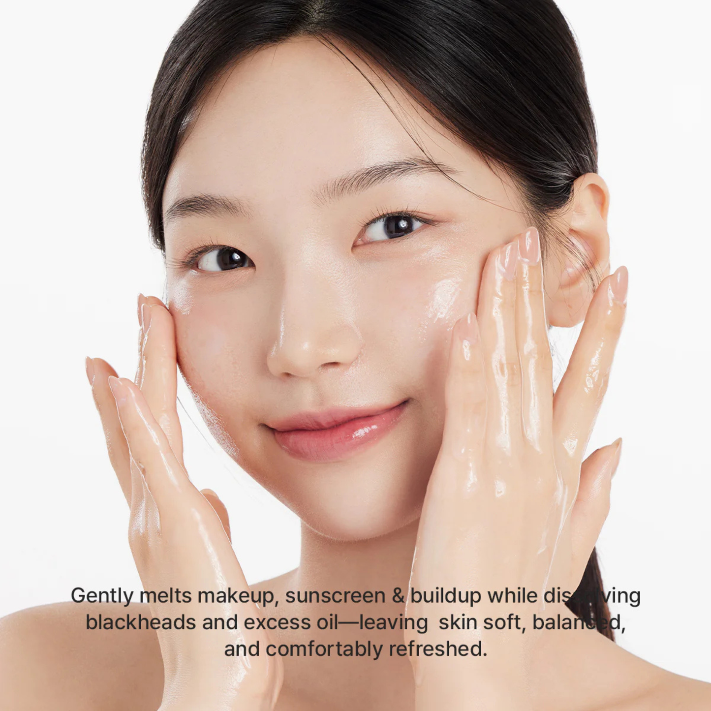 Woman applyingArencia Pore Melt Mochi Cleansing Oil with text about its benefits on a white background