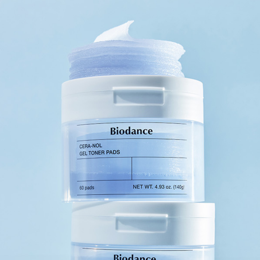 Biodance Cera-Nol Gel Toner Pads in a clear jar with a white lid and a blue-toned gel pad visible, shown against a light blue background with a second jar partially visible below.