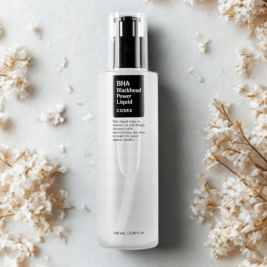 Cosrx BHA Blackhead Power Liquid bottle on a light background with flowers