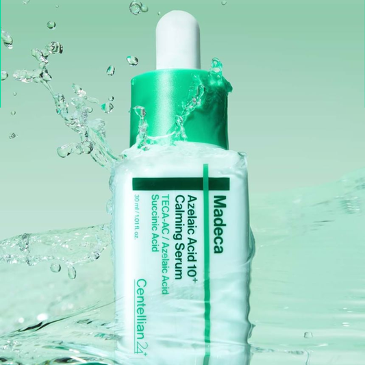 Centellian24 Madeca Azelaic Acid 10+ Calming Serum bottle with water droplets on a green background