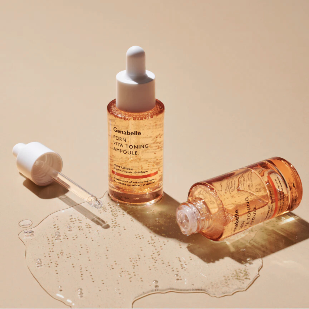 Two bottles of Genabelle Vita Toning Ampoule on a beige background
