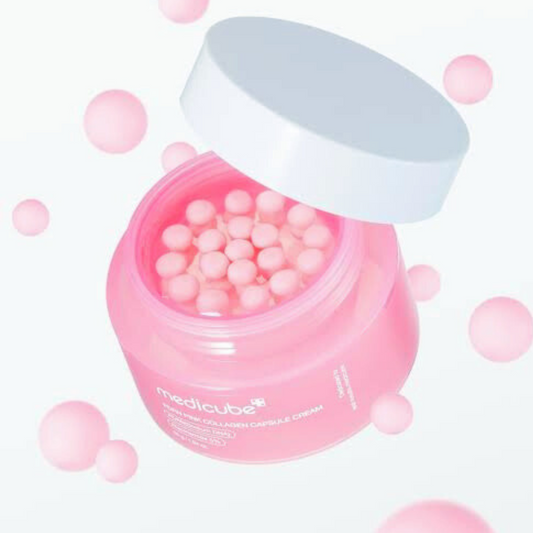 Pink jar with white lid containing small pink balls on a white background. Medicube PDRN Pink Collagen Capsule Cream
