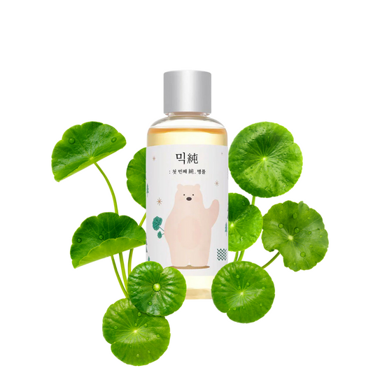 Mixsoon Soondy Centella Asiatica Essence surrounded by centella asiatica on a white background
