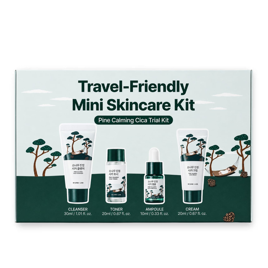 A boxed ROUND LAB Pine Calming Cica Trial Kit labeled 'Travel-Friendly Mini Skincare Kit' with four product containers shown on the front: cleanser, toner, ampoule, and cream. The packaging has a pale mint background, dark green lower band, and illustrated trees and a deer.