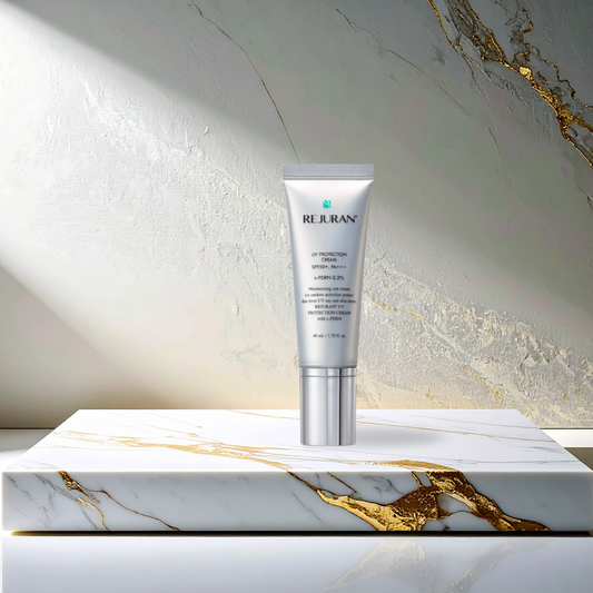 Rejuran UV Protection Cream SPF50+ PA+++ ona marble platform with gold inlay and a stone and marble background