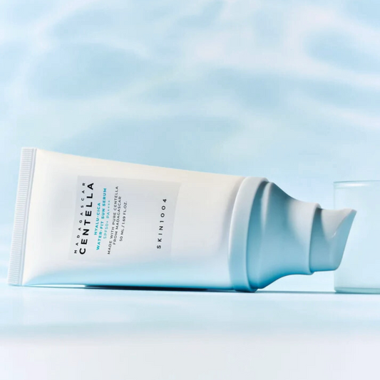 SKIN1004 Hyalu‑Cica Water‑Fit Sun Serum SPF 50+ PA++++ on a light blue background with water refleciton