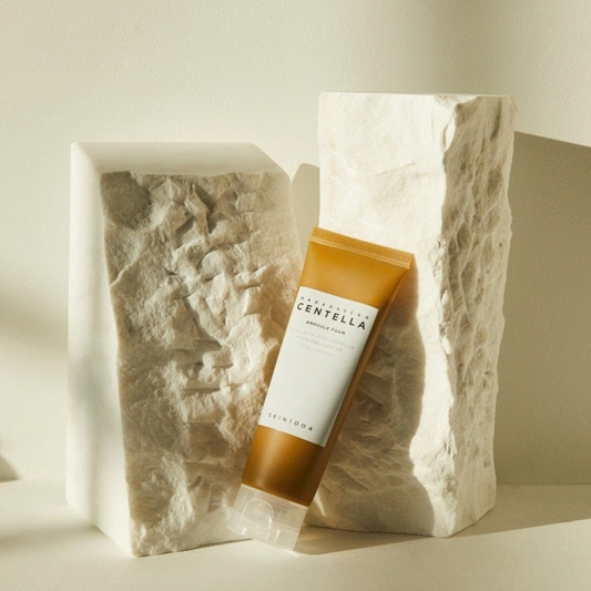 SKIN1004 Madagascar Centella Ampoule Foam tube angled against natural stone on a neutral background