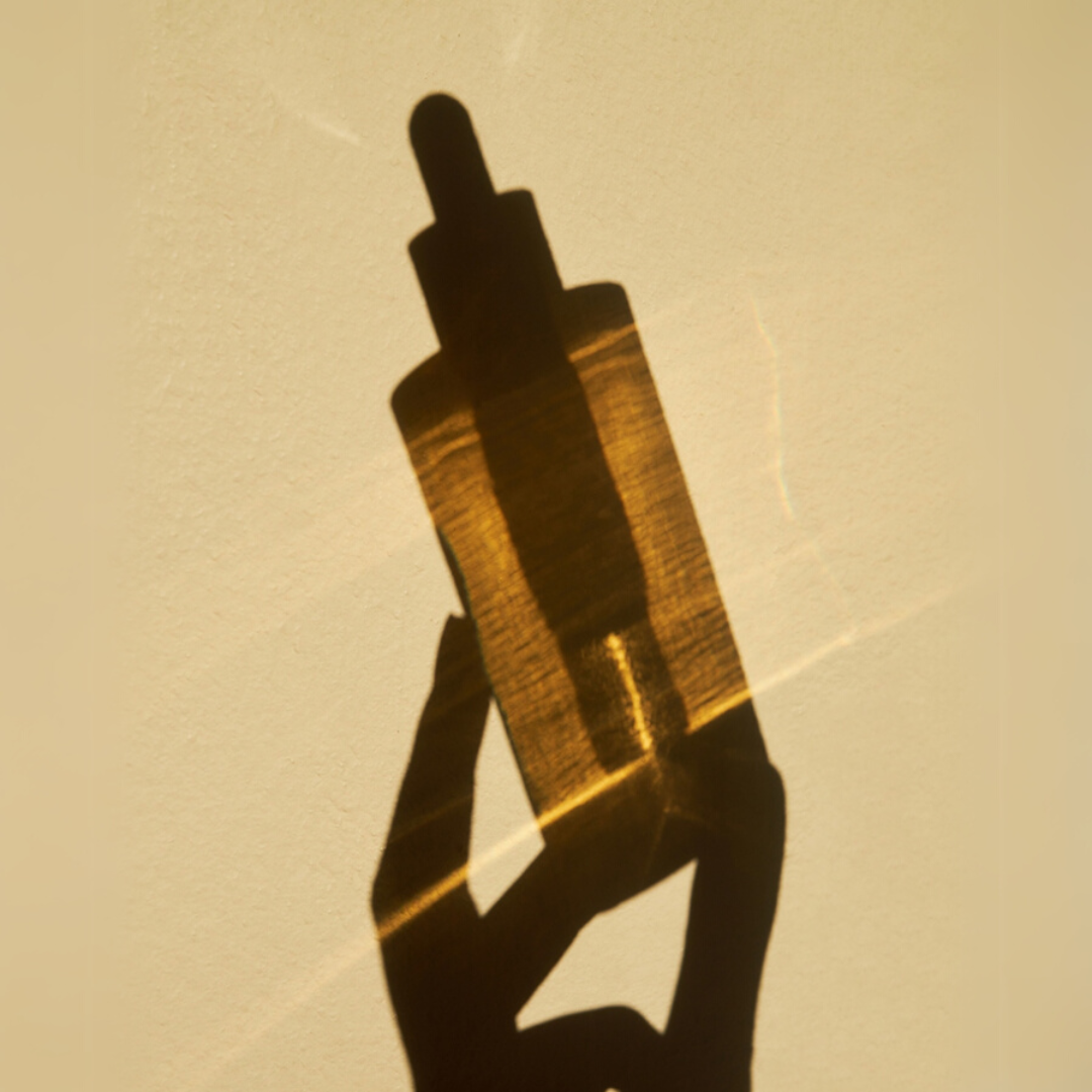 Shadow of SKIN1004 Madagascar Centella Ampoule on a beige background