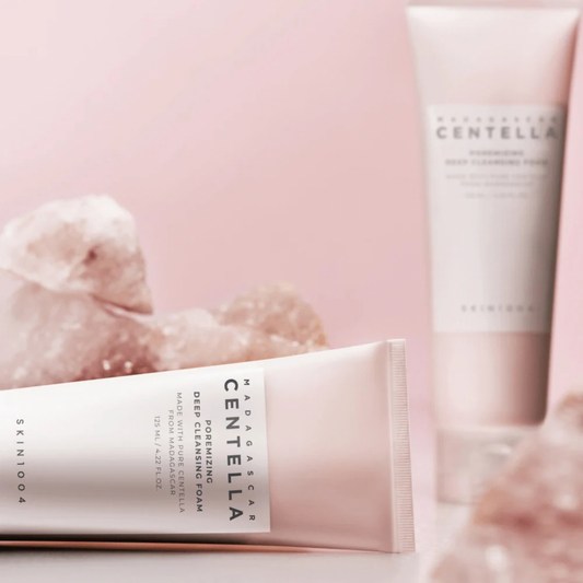 Two tubes of SKIN1004 Madagascar Centella Poremizing Deep Cleansing Foam on a pink background with Himalayan Pink Salt in the background