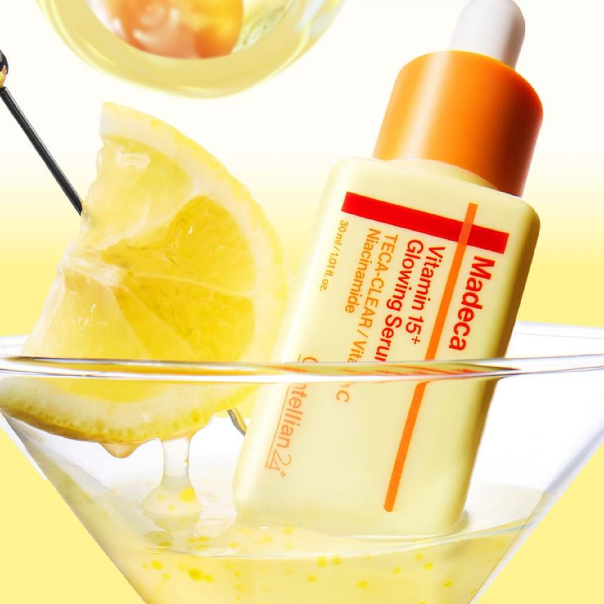 Centellian24 Madeca Vitamin 15+ Glowing Serum in a Martini glass with a lemon slice on a yellow background