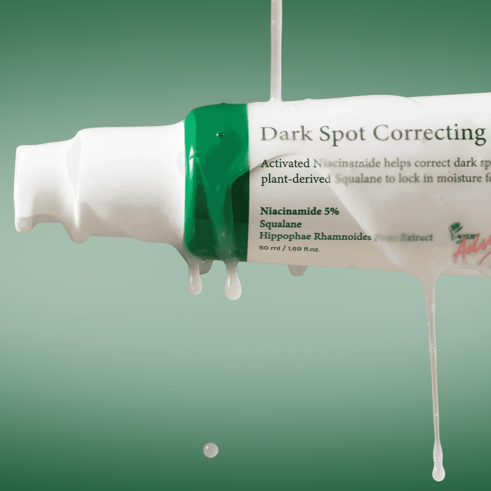 Axis-y Dark Spot Correcting Serum on a green background