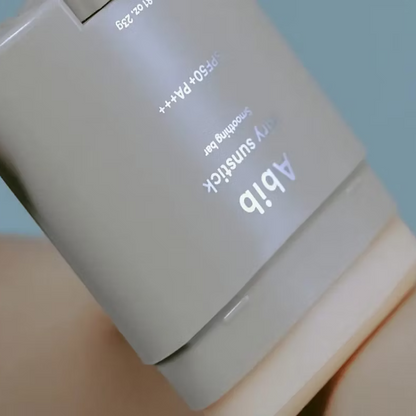 Close-up of Abib Airy Sunstick Smoothing Bar SPF50+ PA++++ on a light blue background