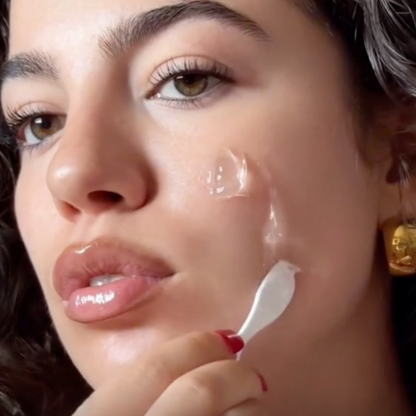 Close-up of a woman applying Abib Rice Probiotics Overnight Mask Barrier Jelly to her face with a spatula