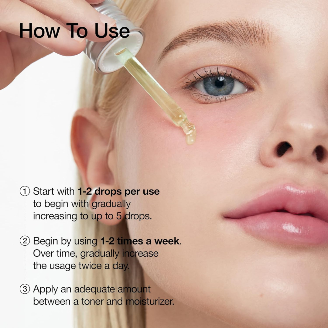 Close-up of a person applying a dropper of Anua Azelaic Acid 10 Hyaluron Redness Soothing Serum to their cheek area with usage instructions.