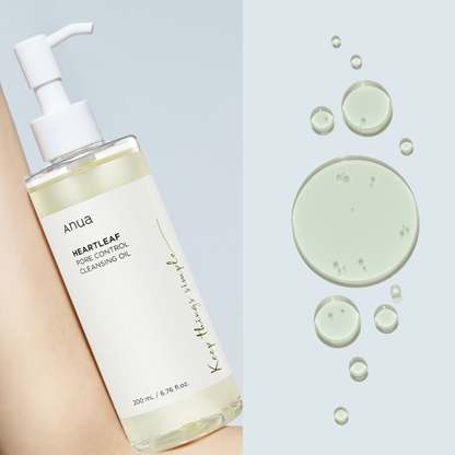 Anua Heartleaf Pore Control Cleansing Oil bottle with oil droplets on a light blue background