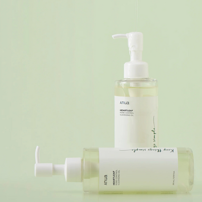 Two bottles of Anua Heartleaf Cleansing Oil on a light green background