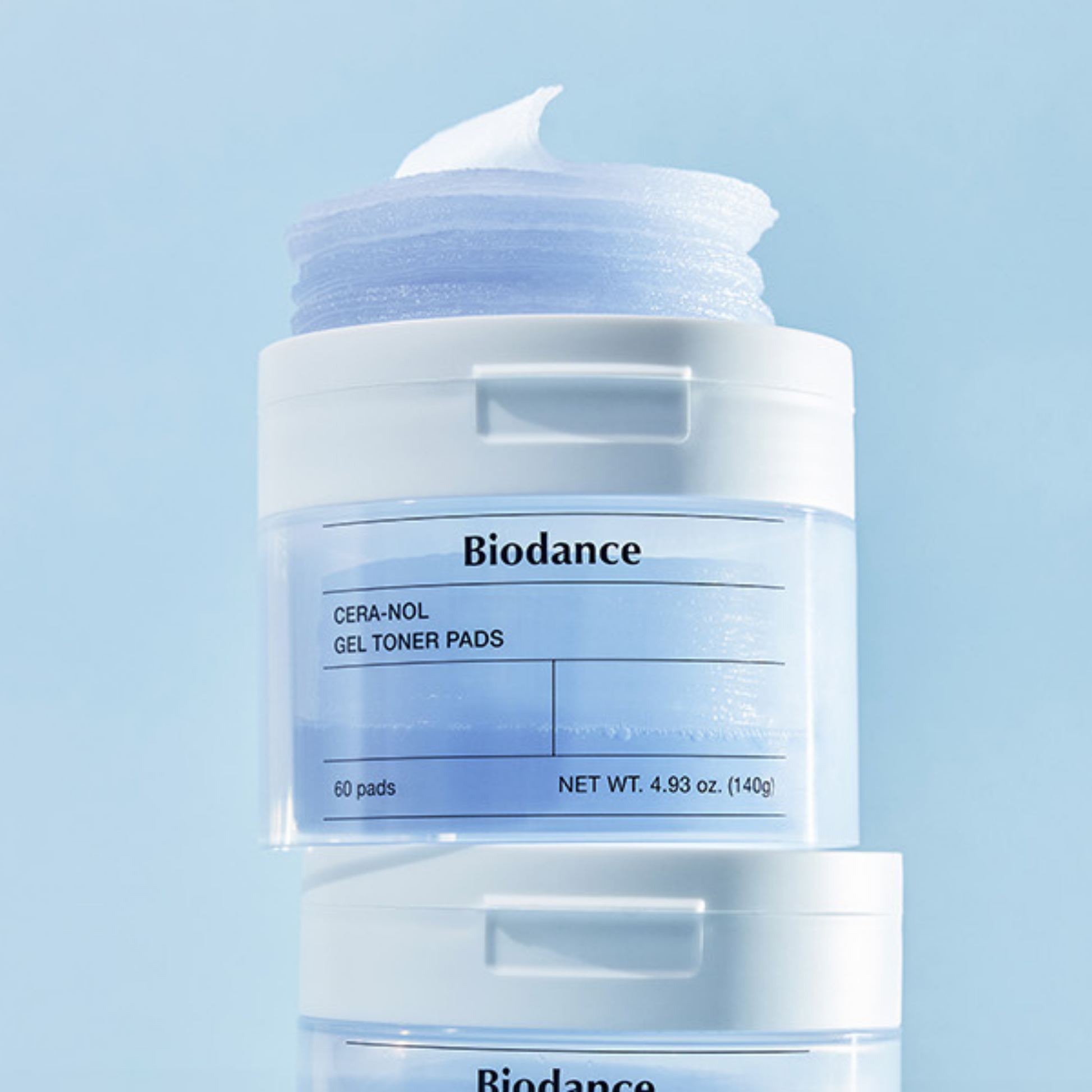 Biodance Cera-Nol Gel Toner Pads in a clear jar with a white lid and a blue-toned gel pad visible, shown against a light blue background with a second jar partially visible below.