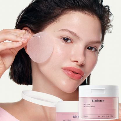 A woman applies a translucent pink gel Biodance Collagen Gel Toner Pad to her cheek. Two jars of Biodance Collagen Gel Toner Pads are shown in the foreground against a clean white background.