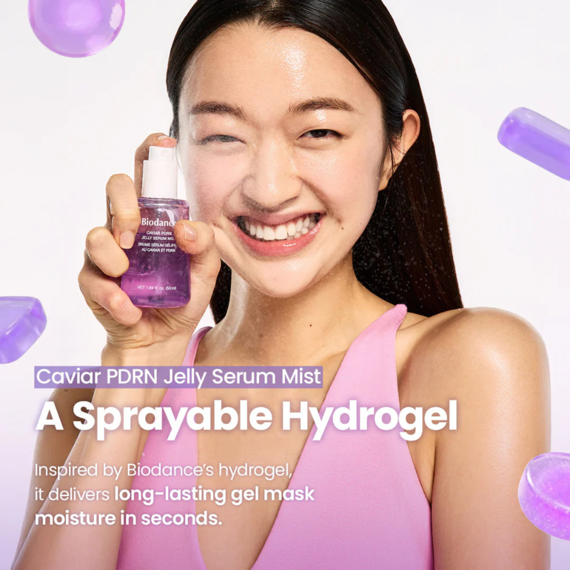 Woman holding a BIODANCE Caviar PDRN Jelly Serum Mist bottle with text about a sprayable hydrogel product.