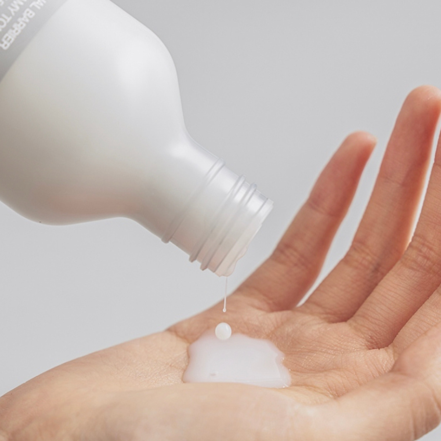 Close-up of Celimax Dual Barrier Creamy Toner being poured onto a hand to showcase the texture
