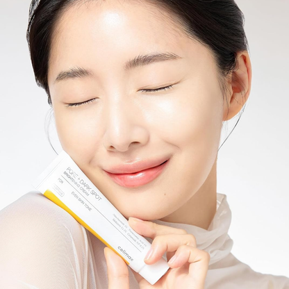 woman holding Celimax Pore+Dark Spot Brightening Cream and smiling with her eyes closed