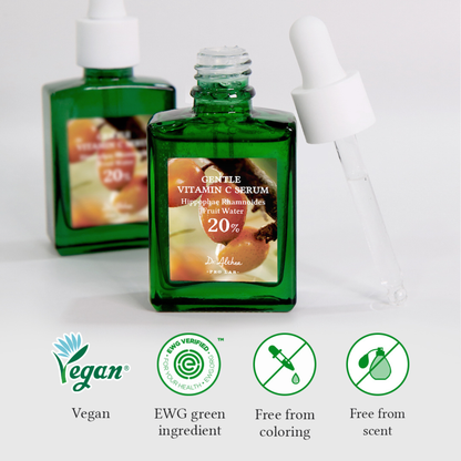 Green Dr.Althea Gentle Vitamin C Serum bottle with labels indicating vegan, EWG green ingredient, free from coloring, and free from scent on a light grey background.