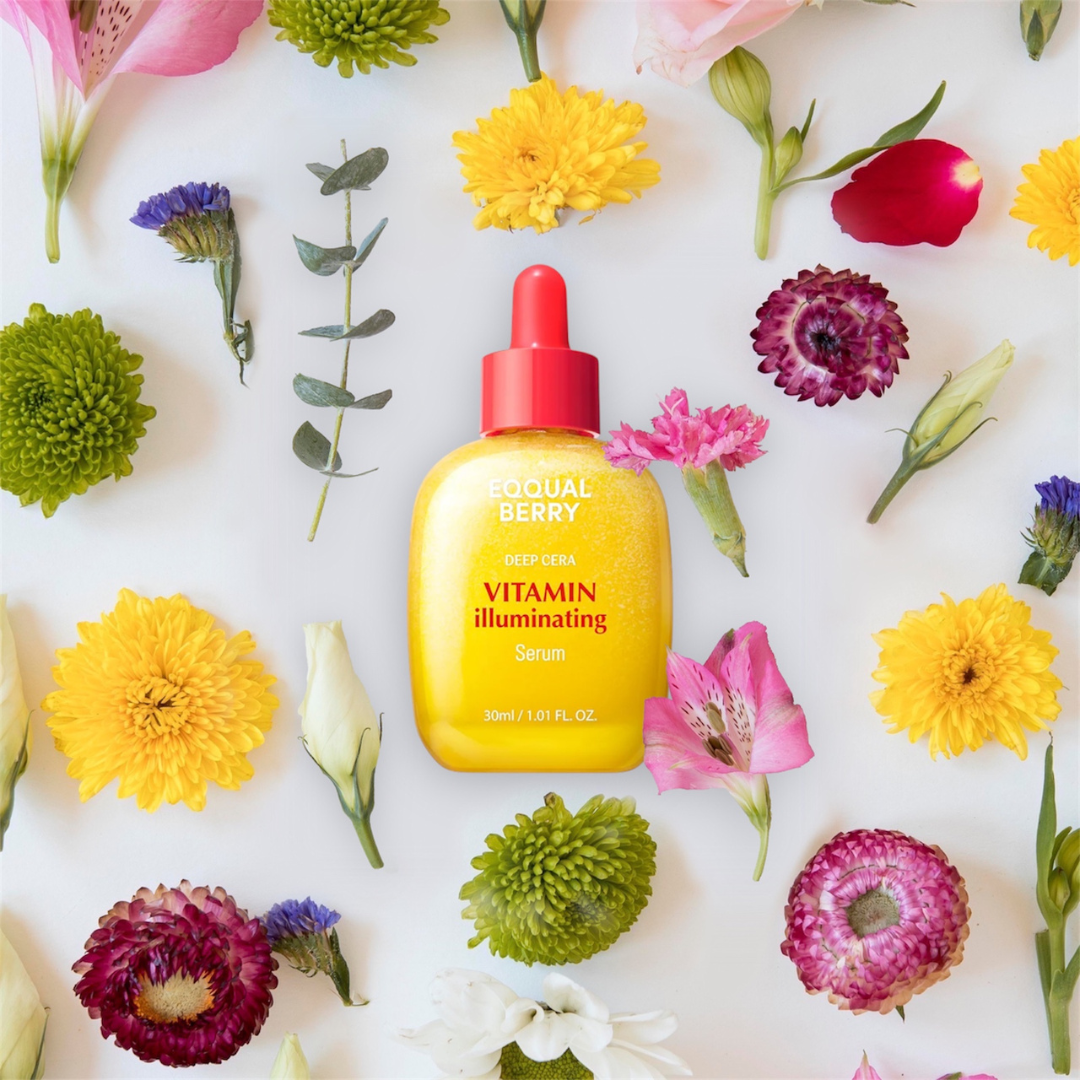 EQQUALBERRY Vitamin Illuminating Serum with red cap on a white background surrounded by colorful flowers