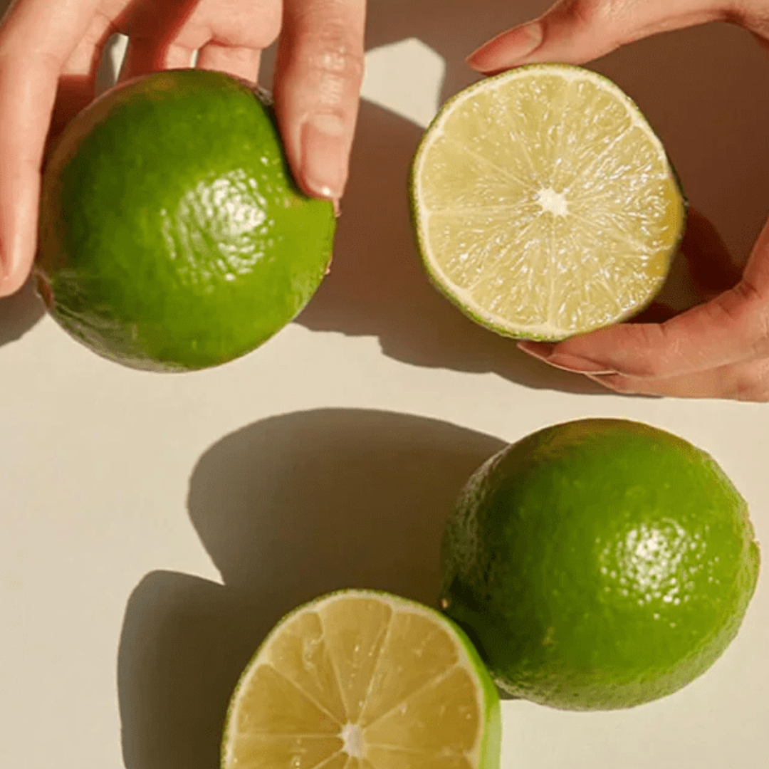 Hands holding green tangerines cut in half