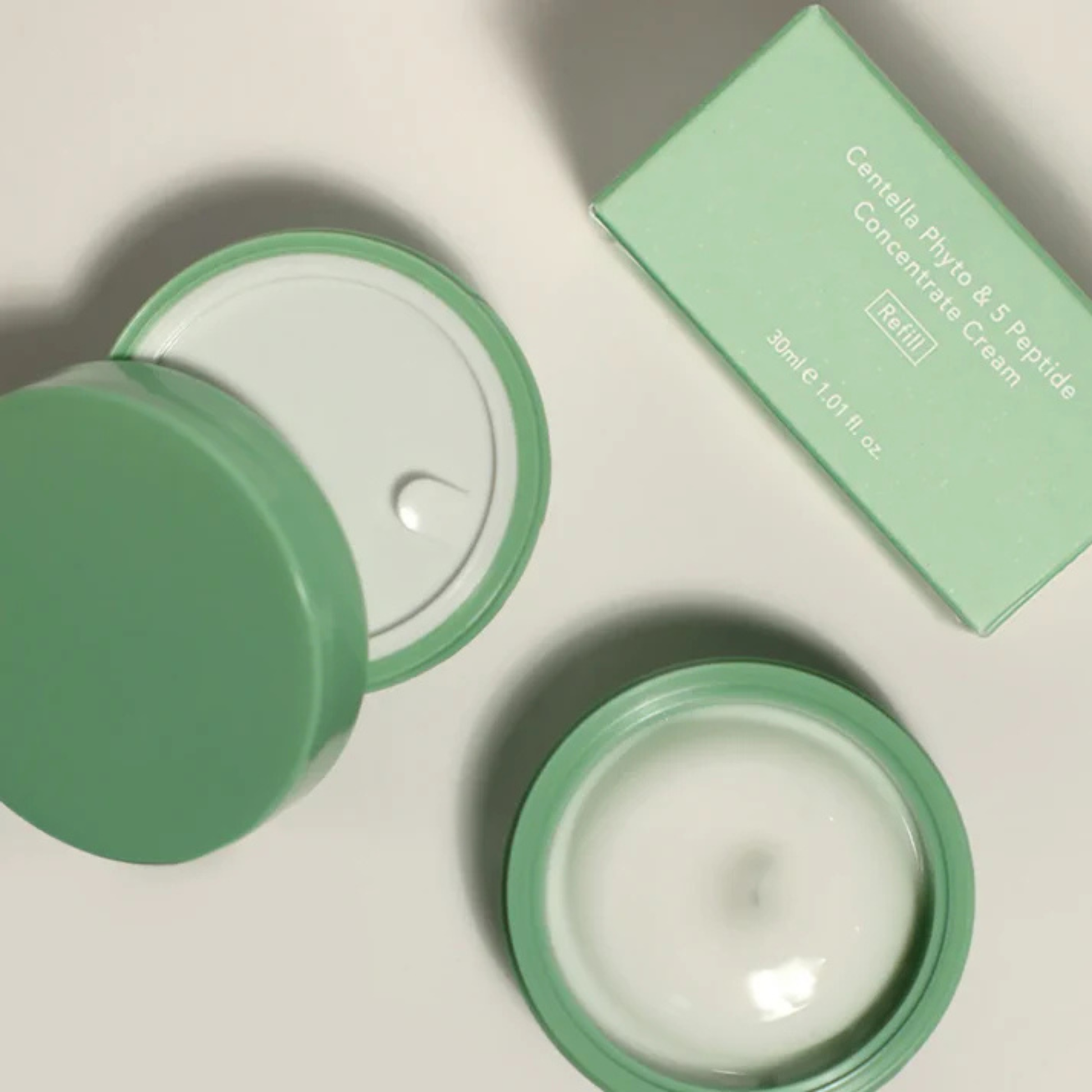 Green Haruharu Wonder Centella Phyto & 5 Peptide Concentrate Cream Refill with open lid on a light background