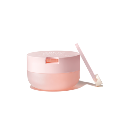 Pink container of LANEIGE Bouncy & Firm Lip Treatment with the applicator on a white background