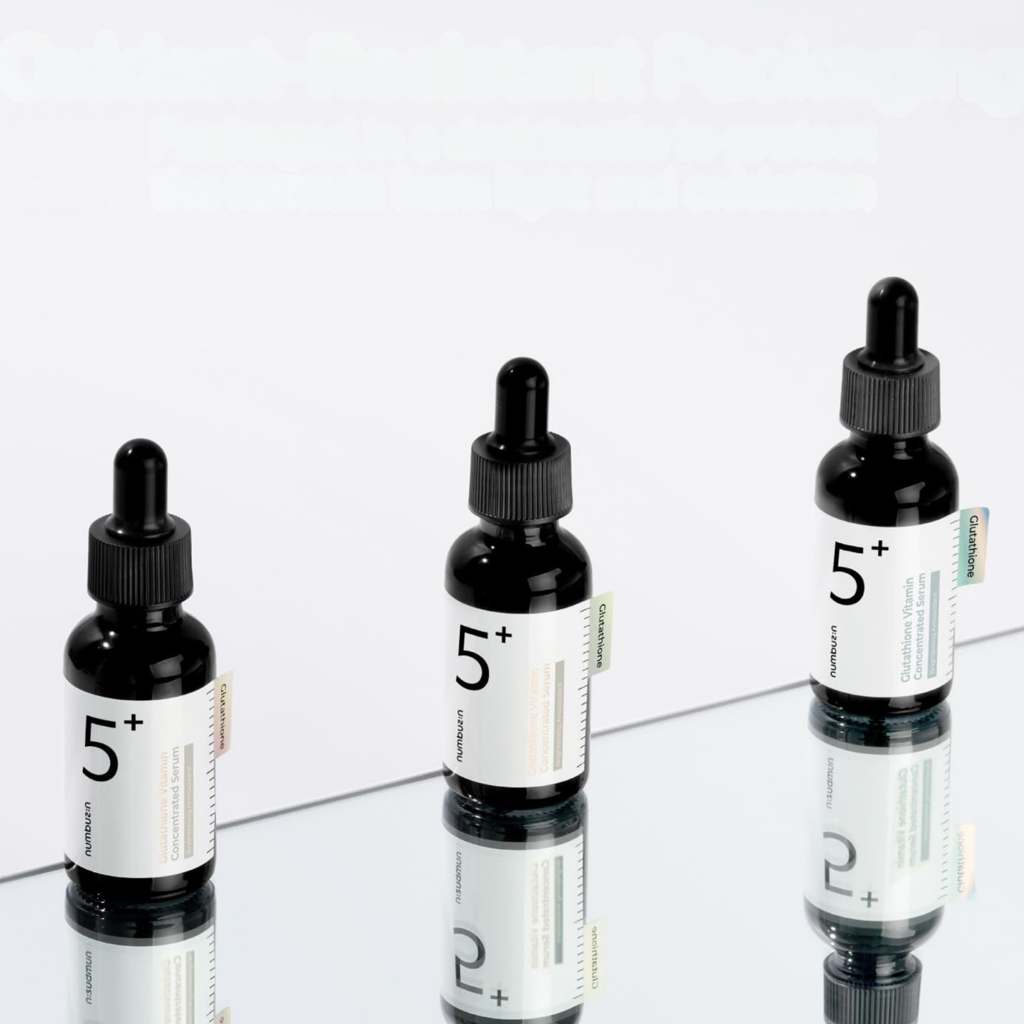 Three bottles of Numbuzin No.5 Glutathione Vitamin Concentrated Serum on a mirrored platform with a white background