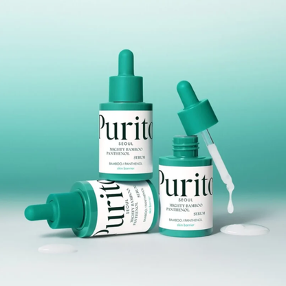 Three Purito Mighty Bamboo Panthenol Serum bottles with droppers on a light green background