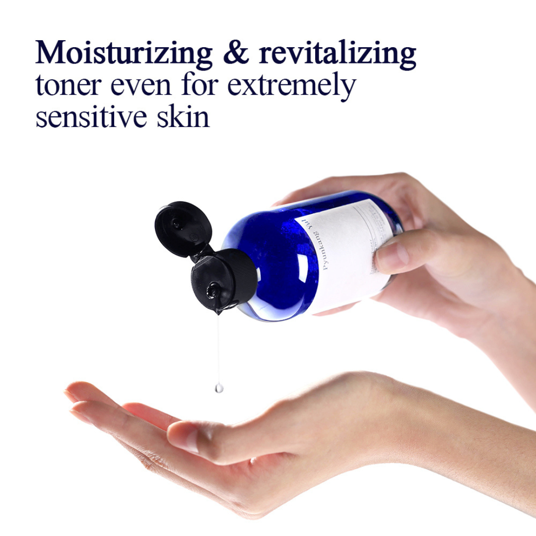 Hand holding Pyunkang Yul Essence Toner over another hand with text about moisturizing and revitalizing for sensitive skin.