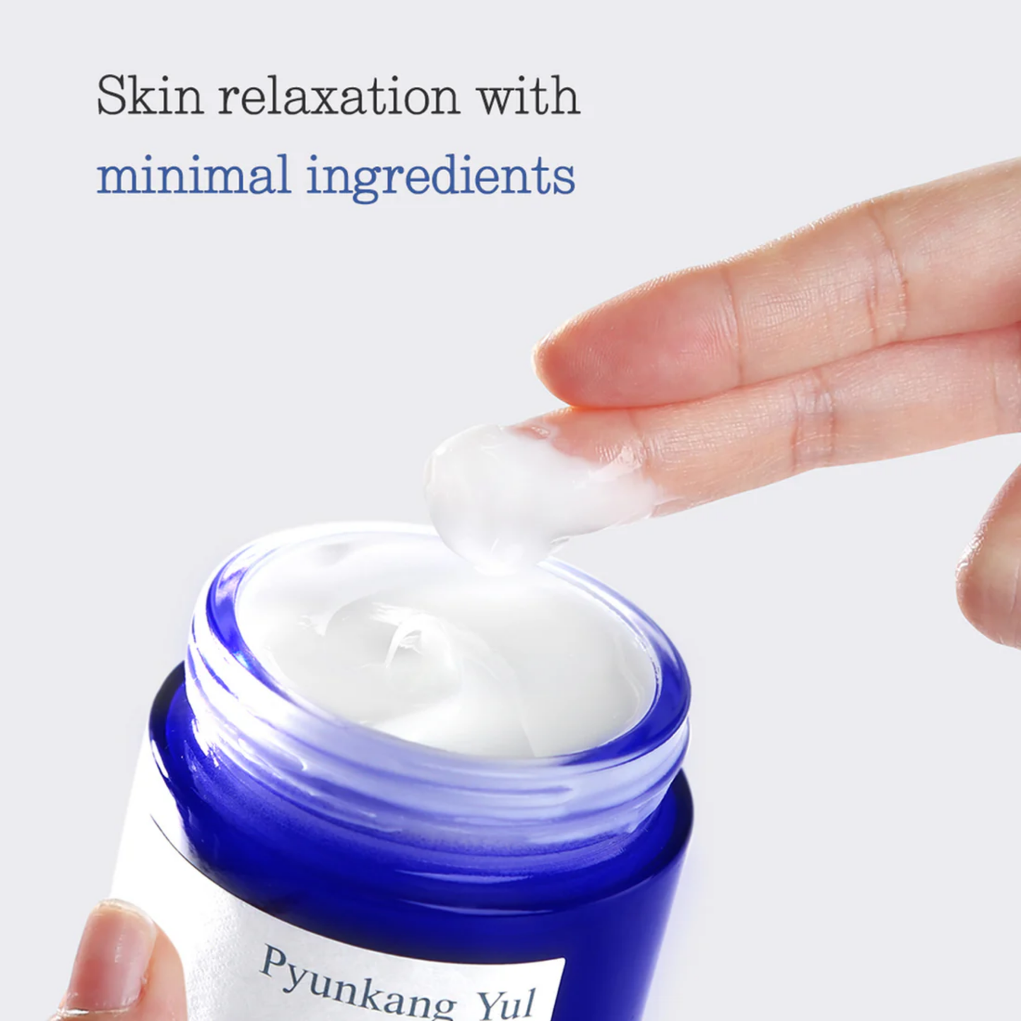 Pyunkang Yul Moisture Cream jar with hand applying cream on a light blue background