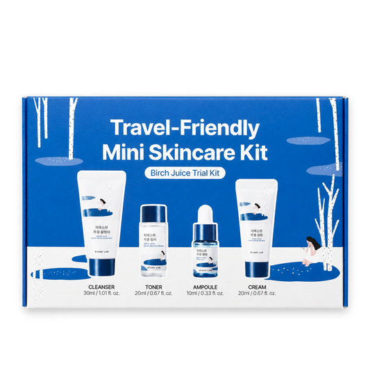 A blue and white Round Lab Birch Juice Trial Kit box labeled 'Travel-Friendly Mini Skincare Kit' with four product containers pictured on the front: cleanser, toner, ampoule, and cream.