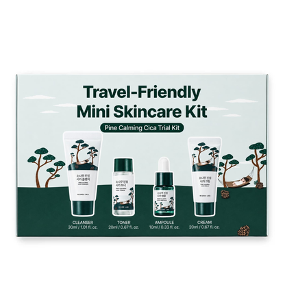 A boxed ROUND LAB Pine Calming Cica Trial Kit labeled 'Travel-Friendly Mini Skincare Kit' with four product containers shown on the front: cleanser, toner, ampoule, and cream. The packaging has a pale mint background, dark green lower band, and illustrated trees and a deer.