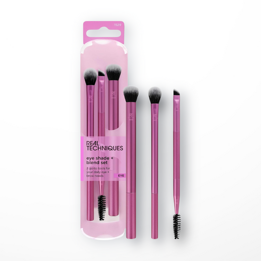 Real Techniques Eye Shade + Blend Set packaging with three makeup brushes visible, including a crease brush, a base shadow brush, and an angled brow brush.