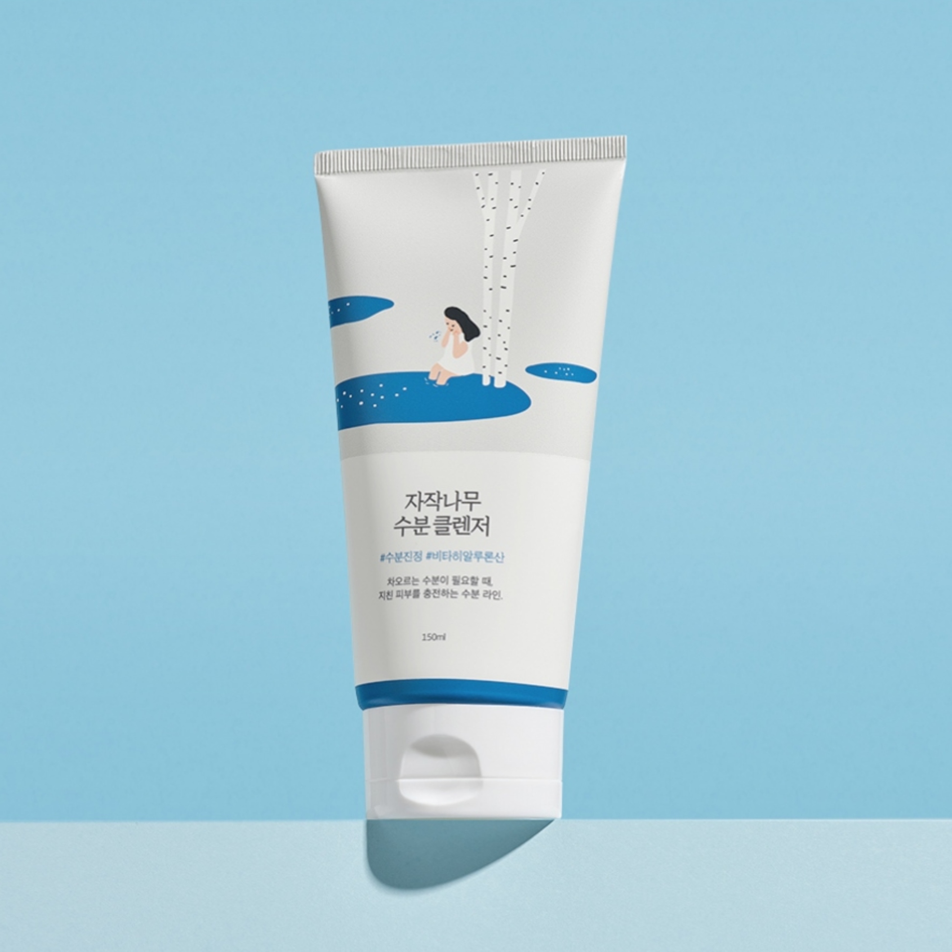 Tube of Round Lab Birch Juice Moisturizing Cleanser with blue and white design on a light blue background