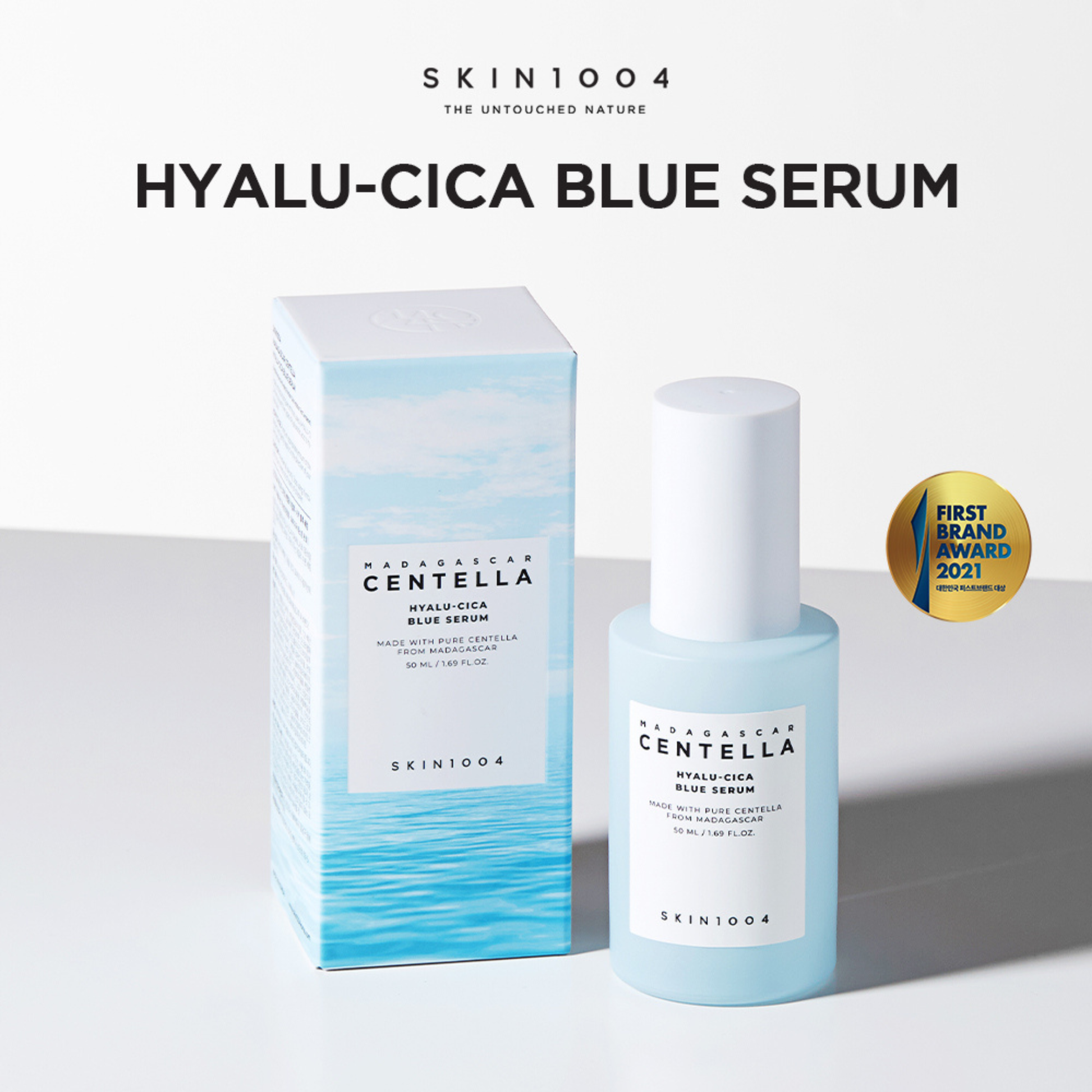SKIN1004 Hyalu-Cica Blue Serum on a grey platform with white background and  product box