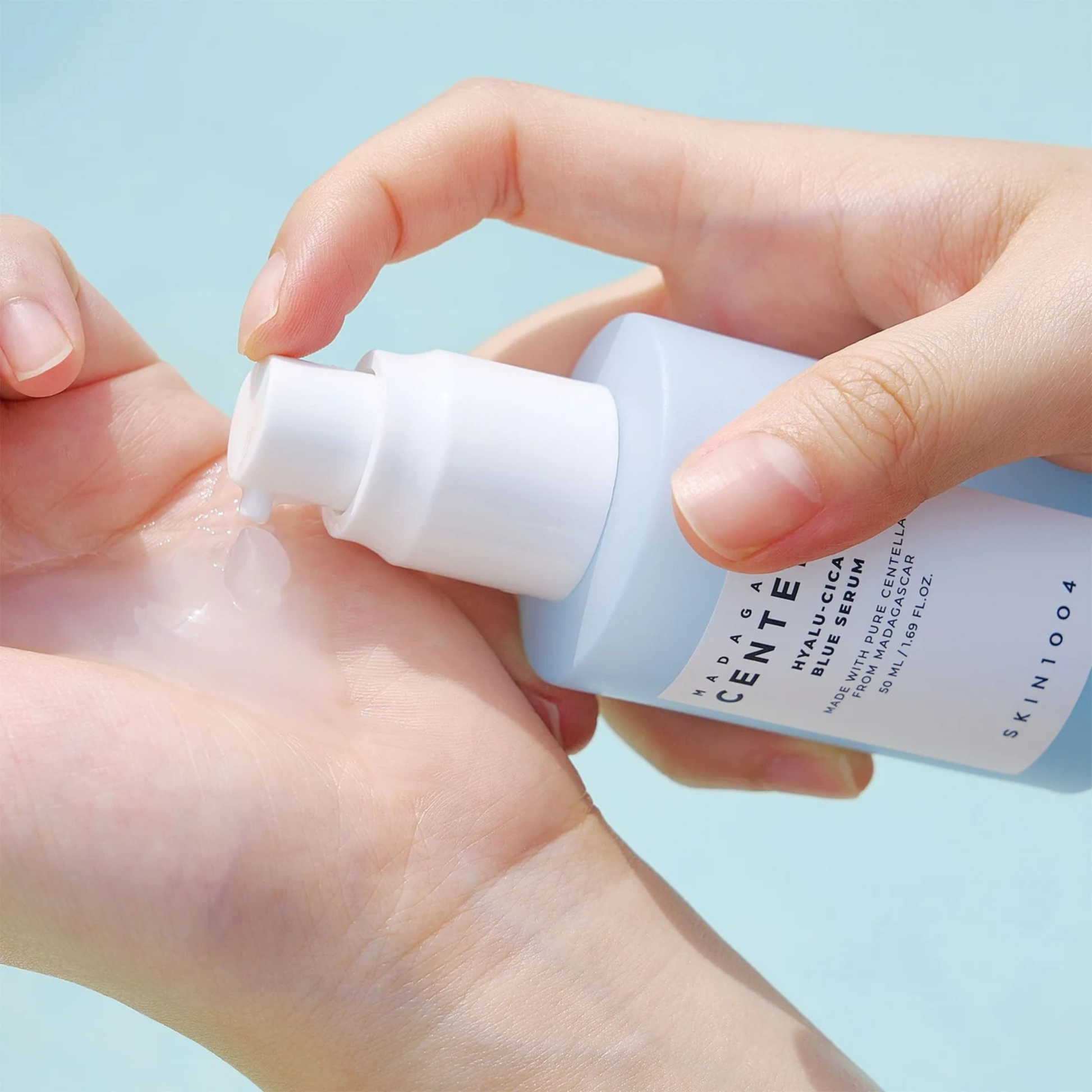 Close up of SKIN1004 Hyalu-Cica Blue Serum being pumped onto a hand