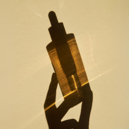 Shadow of SKIN1004 Madagascar Centella Ampoule on a beige background