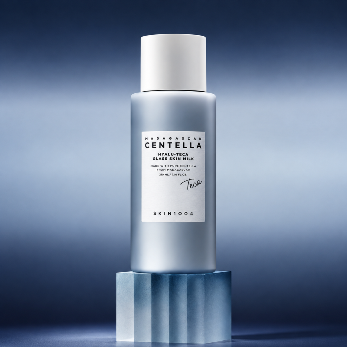 SKIN1004 Madagascar Centella Hyalu-Teca Glass Skin Milk on a blue pedestal with a gradient blue background