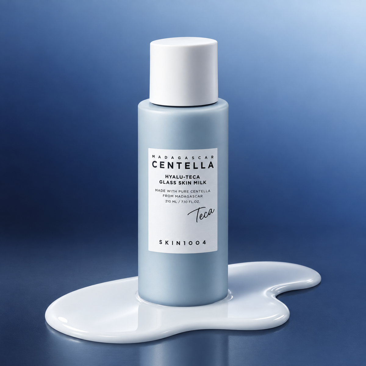 SKIN1004 Madagascar Centella Hyalu-Teca Glass Skin Milk standing on an essence splash on a gradient blue background