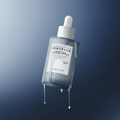 SKIN1004 Madagascar Centella Hyalu-Teca Plumping Ampoule with serum dripping form the ampoule on a gradient blue background