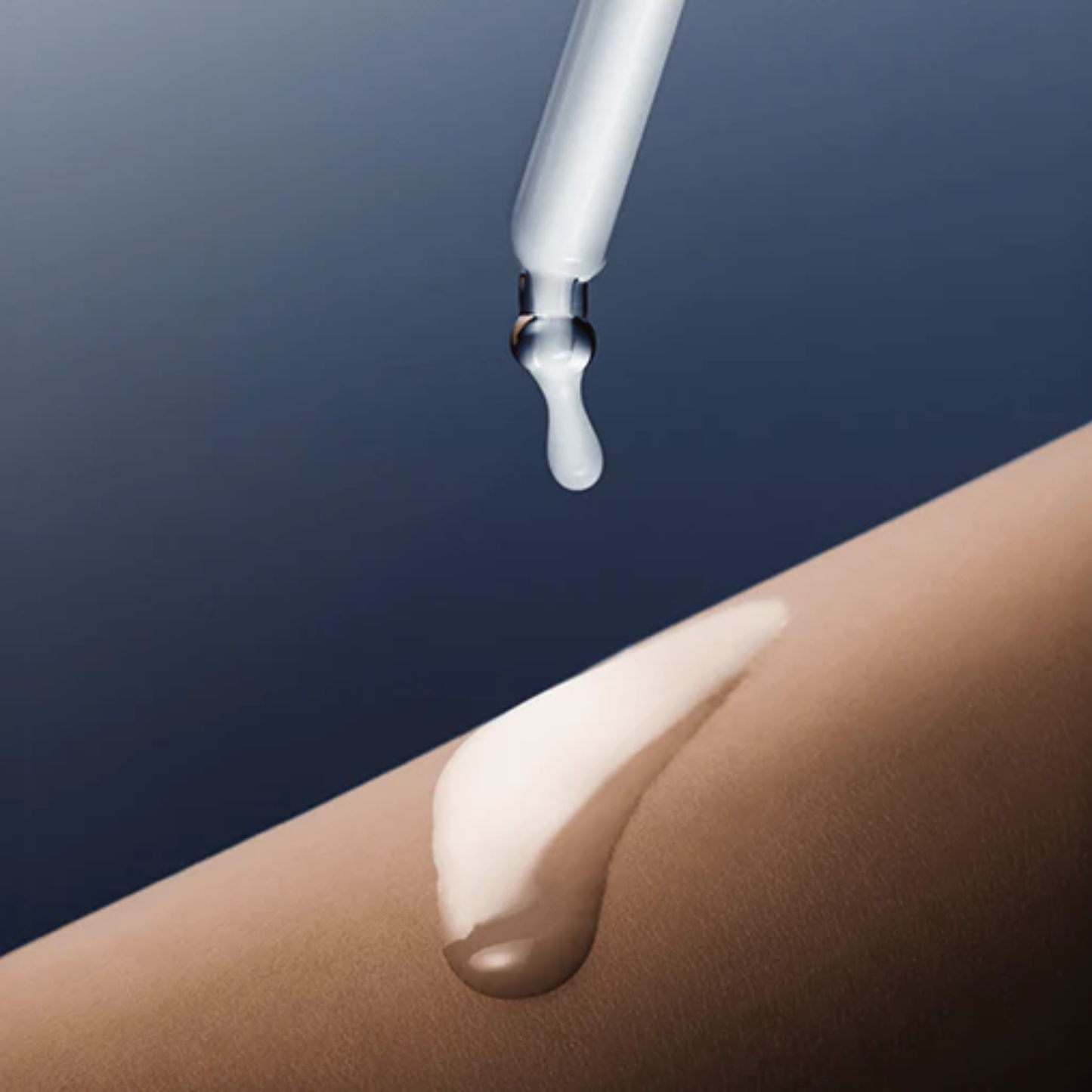 Close up of woman dripping the SKIN1004 Madagascar Centella Hyalu-Teca Plumping Ampoule onto her arm