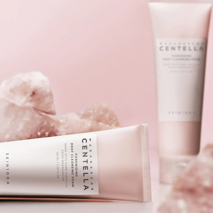 Two tubes of SKIN1004 Madagascar Centella Poremizing Deep Cleansing Foam on a pink background with Himalayan Pink Salt in the background